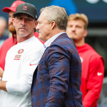 Sep 7, 2025; Seattle, Washington, USA; San Francisco 49ers general manager John Lynch, right, talks with head coach Kyle Shanahan during pregame warmups against the Seattle Seahawks at Lumen Field. Mandatory Credit: Joe Nicholson-Imagn Images