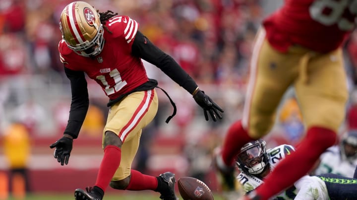 Dec 10, 2023; Santa Clara, California, USA; San Francisco 49ers wide receiver Brandon Aiyuk (11) fumbles the ball in front of Seattle Seahawks safety Julian Love (20) in the fourth quarter at Levi's Stadium. Mandatory Credit: Cary Edmondson-USA TODAY Sports