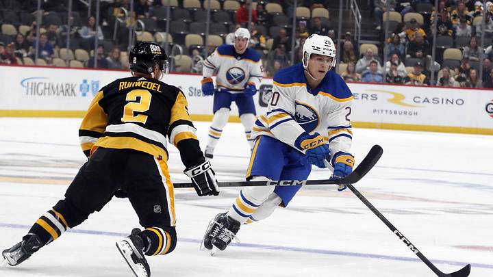 Sep 28, 2023; Pittsburgh, Pennsylvania, USA; Buffalo Sabres center Jiri Kulich (20) moves the puck against Pittsburgh Penguins defenseman Chad Ruhwedel (2) during the first period at PPG Paints Arena. Mandatory Credit: Charles LeClaire-USA TODAY Sports