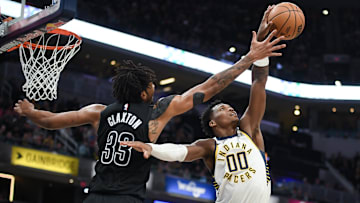 Mar 22, 2025; Indianapolis, Indiana, USA; Indiana Pacers guard Bennedict Mathurin (00) steals a pass from Brooklyn Nets center Nic Claxton (33) during the second half at Gainbridge Fieldhouse. Mandatory Credit: Robert Goddin-Imagn Images