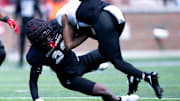 Cincinnati Bearcats cornerback Willie Goodwyn (23) tackles Cincinnati Bearcats wide receiver Noah Jennings (8) during the Cincinnati Bearcats football spring practice at Nippert Stadium on Saturday, April 12, 2025.
