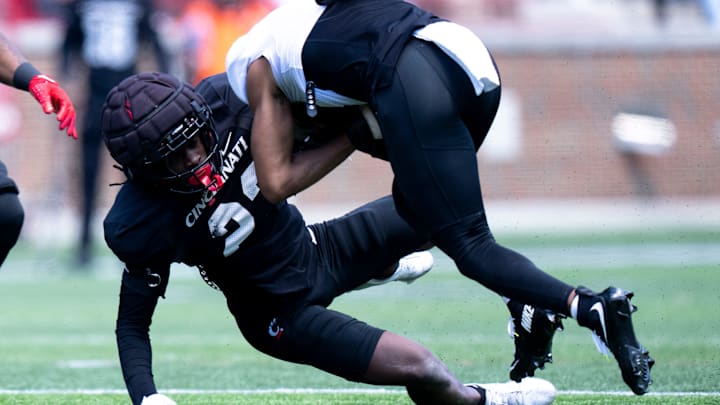 Cincinnati Bearcats cornerback Willie Goodwyn (23) tackles Cincinnati Bearcats wide receiver Noah Jennings (8) during the Cincinnati Bearcats football spring practice at Nippert Stadium on Saturday, April 12, 2025. Cincinnati Bearcats cornerback Willie Goodwyn (23) tackles Cincinnati Bearcats wide receiver Noah Jennings (8) during the Cincinnati Bearcats football spring practice at Nippert Stadium on Saturday, April 12, 2025.