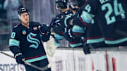 Mar 12, 2025; Seattle, Washington, USA;  Seattle Kraken forward Eeli Tolvanen (20) is congratulated by teammates on the bench after scoring a goal during the second period against the Montreal Canadiens at Climate Pledge Arena. Mandatory Credit: Stephen Brashear-Imagn Images