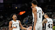 Oct 10, 2025; San Antonio, Texas, USA; San Antonio Spurs guard Dylan Harper (2) reacts after making an alley-oop pass to forward Victor Wembanyama (1) during the first half against the Utah Jazz at Frost Bank Center. Mandatory Credit: Scott Wachter-Imagn Images