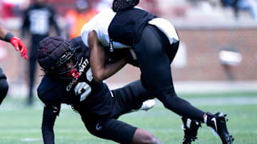 Cincinnati Bearcats cornerback Willie Goodwyn (23) tackles Cincinnati Bearcats wide receiver Noah Jennings (8) during the Cincinnati Bearcats football spring practice at Nippert Stadium on Saturday, April 12, 2025.