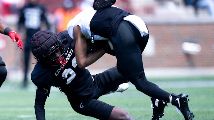 Cincinnati Bearcats cornerback Willie Goodwyn (23) tackles Cincinnati Bearcats wide receiver Noah Jennings (8) during the Cincinnati Bearcats football spring practice at Nippert Stadium on Saturday, April 12, 2025.