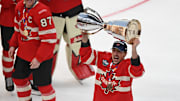 Marchand lift the trophy following Team Canada's 4 Nations Face-Off win.