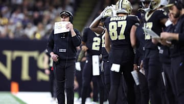 Dec 17, 2023; New Orleans, Louisiana, USA; New Orleans Saints head coach Dennis Allen (left) looks