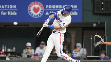 Texas Rangers left fielder Evan Carter (32) hits a triple against the Seattle Mariners during the seventh inning at Globe Life Field on April 24.