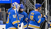 Apr 5, 2025; St. Louis, Missouri, USA;  St. Louis Blues goaltender Jordan Binnington (50) and defenseman Nick Leddy (4) celebrate after the Blues won their franchise record 12th straight win after a victory over the Colorado Avalanche at Enterprise Center. Mandatory Credit: Jeff Curry-Imagn Images