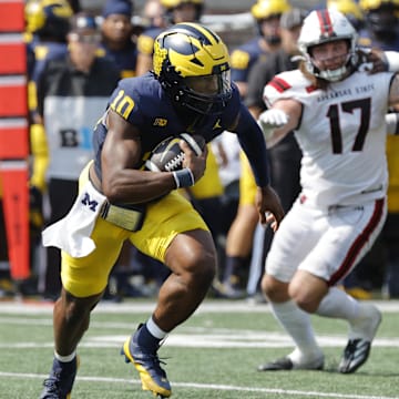 Sep 14, 2024; Ann Arbor, Michigan, USA;  Michigan Wolverines quarterback Alex Orji (10) rushes second half against the Arkansas State Red Wolves at Michigan Stadium. Mandatory Credit: Rick Osentoski-Imagn Images