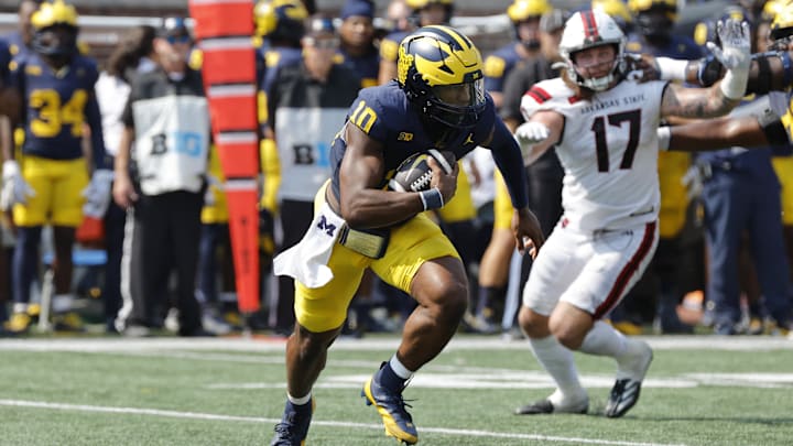 Sep 14, 2024; Ann Arbor, Michigan, USA;  Michigan Wolverines quarterback Alex Orji (10) rushes second half against the Arkansas State Red Wolves at Michigan Stadium. Mandatory Credit: Rick Osentoski-Imagn Images