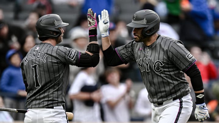 May 11, 2024; New York City, New York, USA; New York Mets designated hitter J.D. Martinez (28) is greeted at home plate by second baseman Jeff McNeil (1) after hitting a solo home run against the Atlanta Braves during the ninth inning at Citi Field. Mandatory Credit: John Jones-USA TODAY Sports