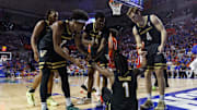 Vanderbilt Commodores guard MJ Collins Jr. (2), forward JaQualon Roberts (24) and guard Grant Huffman (4) help up guard Jason Edwards (1) against the Florida Gators during the first half at Exactech Arena at the Stephen C. O'Connell Center.