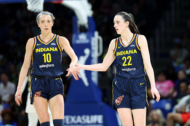 Indiana Fever guard Caitlin Clark celebrates with Indiana Fever guard Lexie Hull against the Dallas Wings.