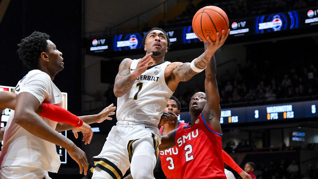 Dec 3, 2025; Nashville, Tennessee, USA;  Vanderbilt Commodores guard Frankie Collins (1) lays the ball in  over Southern Methodist University Mustangs guard Boopie Miller (2) during the first half at Memorial Gymnasium. Mandatory Credit: Steve Roberts-Imagn Images