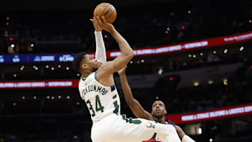 Dec 1, 2025; Washington, District of Columbia, USA; Milwaukee Bucks forward Giannis Antetokounmpo (34) shoots the ball over Washington Wizards forward Khris Middleton (22) in the first quarter at Capital One Arena. Mandatory Credit: Geoff Burke-Imagn Images
