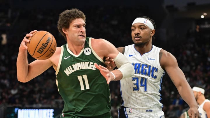 Apr 10, 2024; Milwaukee, Wisconsin, USA;  Milwaukee Bucks center Brook Lopez (11) drives past Orlando Magic center Wendell Carter Jr. (34) in the first quarter at Fiserv Forum. Mandatory Credit: Benny Sieu-USA TODAY Sports