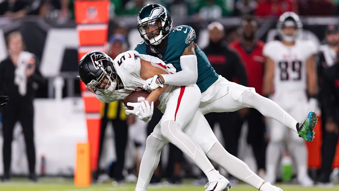 Sep 16, 2024; Philadelphia, Pennsylvania, USA; Atlanta Falcons wide receiver Drake London (5) is tackled by Philadelphia Eagles cornerback Darius Slay Jr. (2) after a catch during the first quarter at Lincoln Financial Field. Mandatory Credit: Bill Streicher-Imagn Images