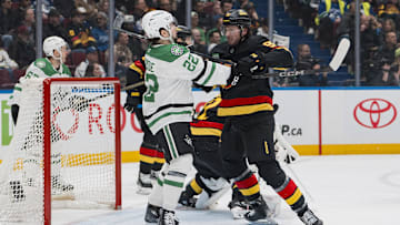 Mar 9, 2025; Vancouver, British Columbia, CAN; Vancouver Canucks defenseman Vittorio Mancini (90) battles with Dallas Stars forward Mavrik Bourque (22) in the first period at Rogers Arena. Mandatory Credit: Bob Frid-Imagn Images