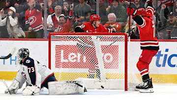 Blue Jackets goaltender Jet Greaves looks on as the Carolina Hurricanes celebrate the eventual game winning goal. 