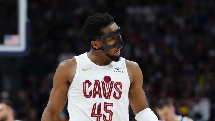 Mar 31, 2024; Denver, Colorado, USA; Cleveland Cavaliers guard Donovan Mitchell (45) reacts after his three point score in the first quarter against the Denver Nuggets at Ball Arena. Mandatory Credit: Ron Chenoy-USA TODAY Sports