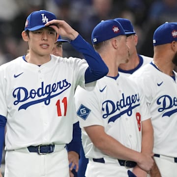 Dodgers pitchers Yoshinobu Yamamoto (left) and Roki Sasaki (11) stand on the field before the game against the Hanshin Tigers at Tokyo Dome. 