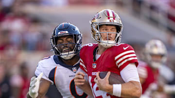 August 19, 2023; Santa Clara, California, USA; San Francisco 49ers quarterback Sam Darnold (14) is hit by Denver Broncos defender Jonathon Cooper. 