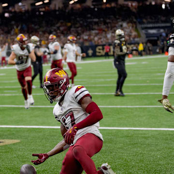 Dec 15, 2024; New Orleans, Louisiana, USA;  Washington Commanders wide receiver Terry McLaurin (17) celebrates a touchdown against the New Orleans Saints cornerback Kool-Aid McKinstry (14) during the first half at Caesars Superdome. Mandatory Credit: Matthew Hinton-Imagn Images