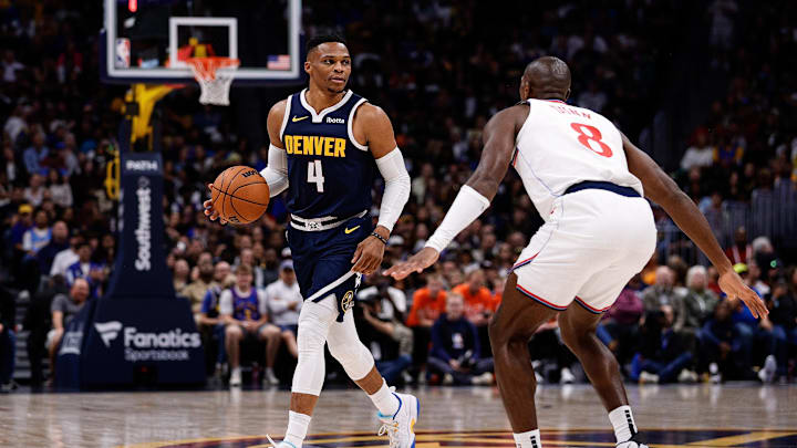 Oct 26, 2024; Denver, Colorado, USA; Denver Nuggets guard Russell Westbrook (4) controls the ball as Los Angeles Clippers guard Kris Dunn (8) guards in the third quarter at Ball Arena. Mandatory Credit: Isaiah J. Downing-Imagn Images