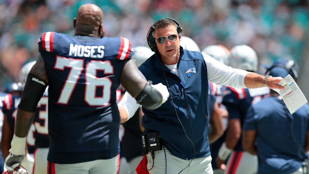 Sep 14, 2025; Miami Gardens, Florida, USA; New England Patriots head coach Mike Vrabel celebrates with offensive tackle Morgan Moses (76) after a play against the Miami Dolphins during the first quarter at Hard Rock Stadium. Mandatory Credit: Sam Navarro-Imagn Images