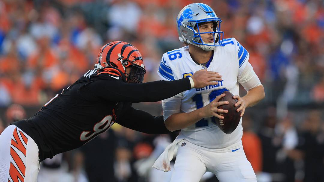 Oct 5, 2025; Cincinnati, Ohio, USA; Detroit Lions quarterback Jared Goff (16) is tackled by Cincinnati Bengals defensive end Trey Hendrickson (91) during the fourth quarter at Paycor Stadium. Mandatory Credit: Katie Stratman-Imagn Images
