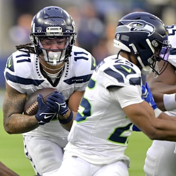 Jan 5, 2025; Inglewood, California, USA; Seattle Seahawks wide receiver Jaxon Smith-Njigba (11) runs the ball in the first half against the Los Angeles Rams at SoFi Stadium.