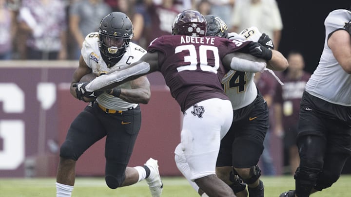 Appalachian State Mountaineers running back Camerun Peoples (6) rushes against Texas A&M Aggies defensive lineman Tunmise Adeleye (30) in the second quarter at Kyle Field. Appalachian State Mountaineers running back Camerun Peoples (6) rushes against Texas A&M Aggies defensive lineman Tunmise Adeleye (30) in the second quarter at Kyle Field.