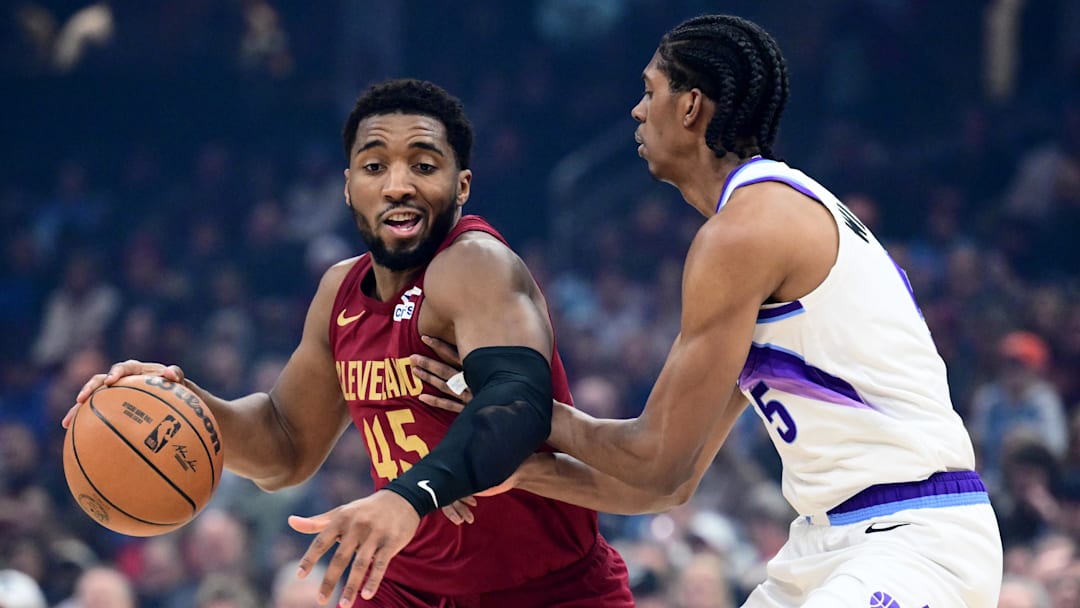 Jan 12, 2026; Cleveland, Ohio, USA; Cleveland Cavaliers guard Donovan Mitchell (45) drives to the basket against Utah Jazz forward Cody Williams (5) during the first quarter at Rocket Arena. Mandatory Credit: Ken Blaze-Imagn Images