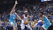 Oct 9, 2025; Oklahoma City, Oklahoma, USA; Oklahoma City Thunder guard Shai Gilgeous-Alexander (2) drives to the basket between Charlotte Hornets forward Tidjane Salaün (31) and forward Brandon Miller (24) during the second quarter of a game between the Charlotte Hornets and the Oklahoma City Thunder at Paycom Center. Mandatory Credit: Alonzo Adams-Imagn Images