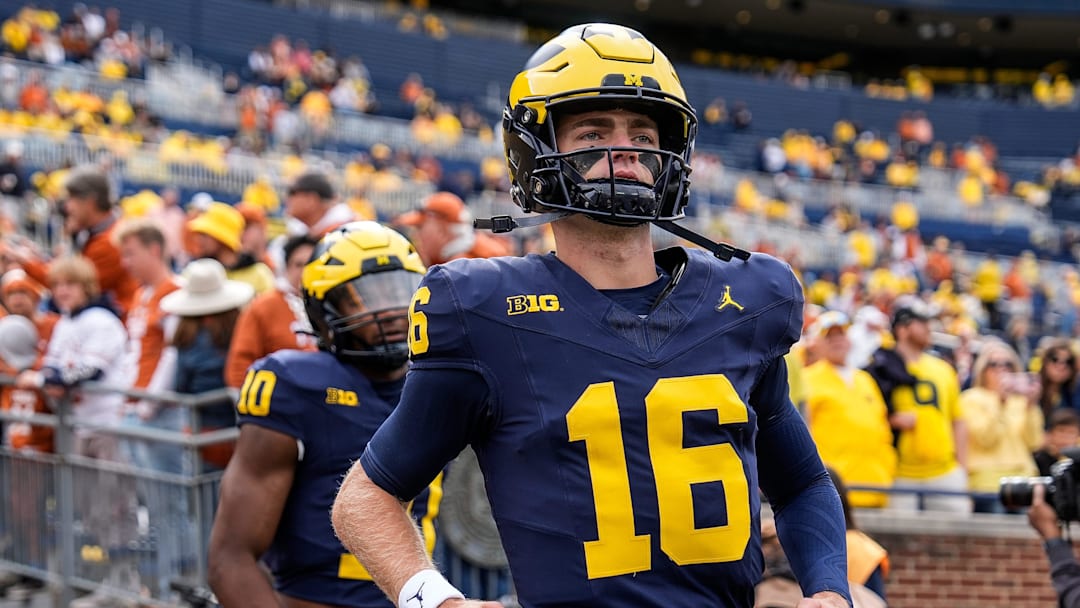 Sep 7, 2024; Ann Arbor, Michigan, USA; Michigan quarterback Davis Warren (16) takes the field for warm ups at Michigan Stadium. Mandatory Credit: Junfu Han-USA TODAY Network via Imagn Images