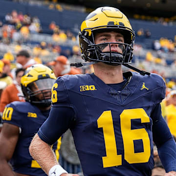 Sep 7, 2024; Ann Arbor, Michigan, USA; Michigan quarterback Davis Warren (16) takes the field for warm ups at Michigan Stadium. Mandatory Credit: Junfu Han-USA TODAY Network via Imagn Images