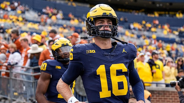 Sep 7, 2024; Ann Arbor, Michigan, USA; Michigan quarterback Davis Warren (16) takes the field for warm ups at Michigan Stadium. Mandatory Credit: Junfu Han-USA TODAY Network via Imagn Images