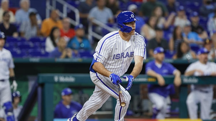 Mar 12, 2023; Miami, Florida, USA; Israel first baseman Matt Mervis (27) hits a single during the