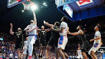 Jan 28, 2025; Lawrence, Kansas, USA; Kansas Jayhawks center Hunter Dickinson (1) shoots as UCF Knights guard Dallan Coleman (6) defends during the second half at Allen Fieldhouse. Mandatory Credit: Denny Medley-Imagn Images