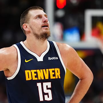 Nov 10, 2024; Denver, Colorado, USA; Denver Nuggets center Nikola Jokic (15) reacts in the second half against the Dallas Mavericks at Ball Arena. Mandatory Credit: Ron Chenoy-Imagn Images