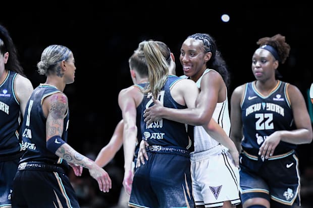 New York Liberty guard Sabrina Ionescu and Golden State Valkyries forward Kayla Thornton embrace. 
