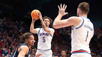 Kansas Jayhawks guard Zeke Mayo (5) looks to make a pass to Kansas Jayhawks center Hunter Dickinson (1) during the first half of the game inside Allen Fieldhouse Tuesday, Nov. 19, 2024.