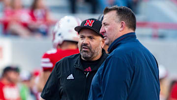 Sep 20, 2024; Lincoln, Nebraska, USA; Nebraska Cornhuskers head coach Matt Rhule and Illinois Fighting Illini head coach Bret Bielema talk before a game at Memorial Stadium. Mandatory Credit: Dylan Widger-Imagn Images