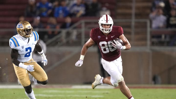 Oct 21, 2023; Stanford, California, USA; Stanford Cardinal tight end Sam Roush (86) runs after a catch against UCLA Bruins linebacker Oluwafemi Oladejo (2) during the third quarter at Stanford Stadium. Mandatory Credit: Darren Yamashita-USA TODAY Sports