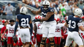 Penn State's Nick Dawkins (53) celebrates a fumble recovery by teammate KJ Winston (21) against Indiana. 