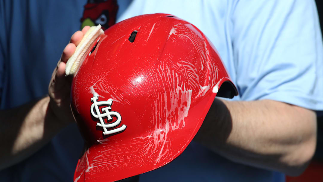 Apr 9, 2025; Pittsburgh, Pennsylvania, USA;  The St. Louis Cardinals equipment manger scrubs the team batting helmets before the game against the Pittsburgh Pirates at PNC Park. Mandatory Credit: Charles LeClaire-Imagn Images