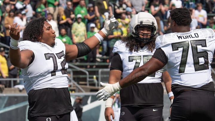 Oregon’s Iapani Laloulu, left, Lipe Moala and Isaiah World dance to the song “Shout” during the Oregon Spring Game at Autzen in Eugene April 26, 2025.