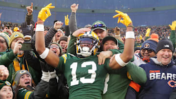 Green Bay Packers wide receiver Dontayvion Wicks (13) celebrates after catching a touchdown pass against Chicago Bears cornerback Terell Smith (32) during their football game Sunday, January 7, 2024, at Lambeau Field in Green Bay, Wis.